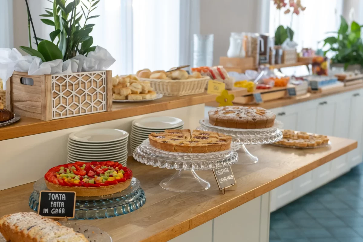 A buffet with various pastries and cakes displayed on a countertop.